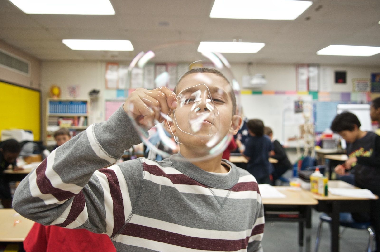 Kid blowing a bubble.