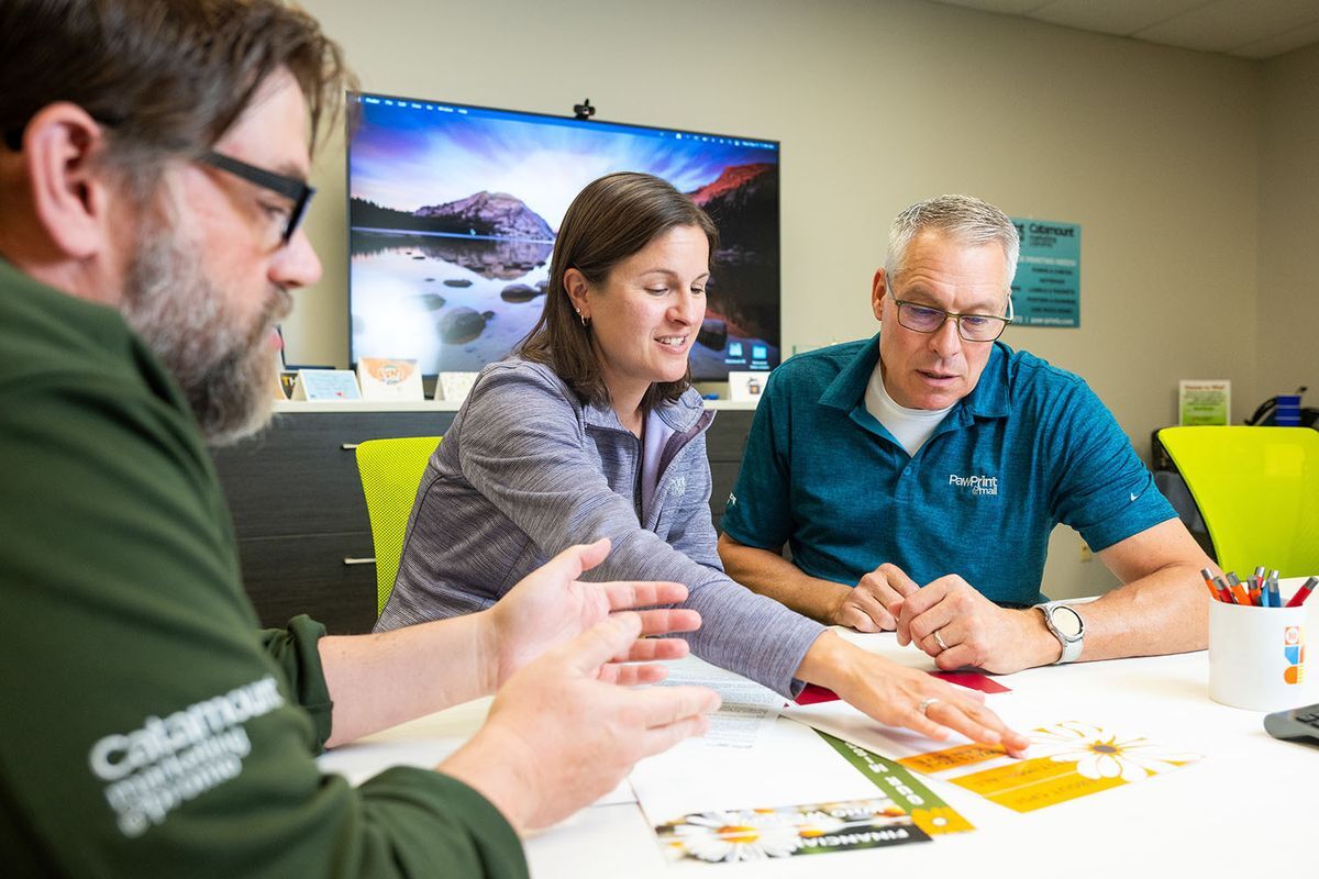 paw print team having a discussion at conference table