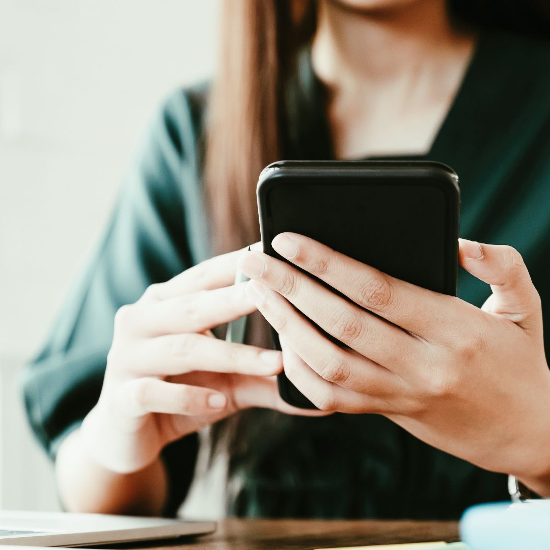 Photo of a woman on her phone.