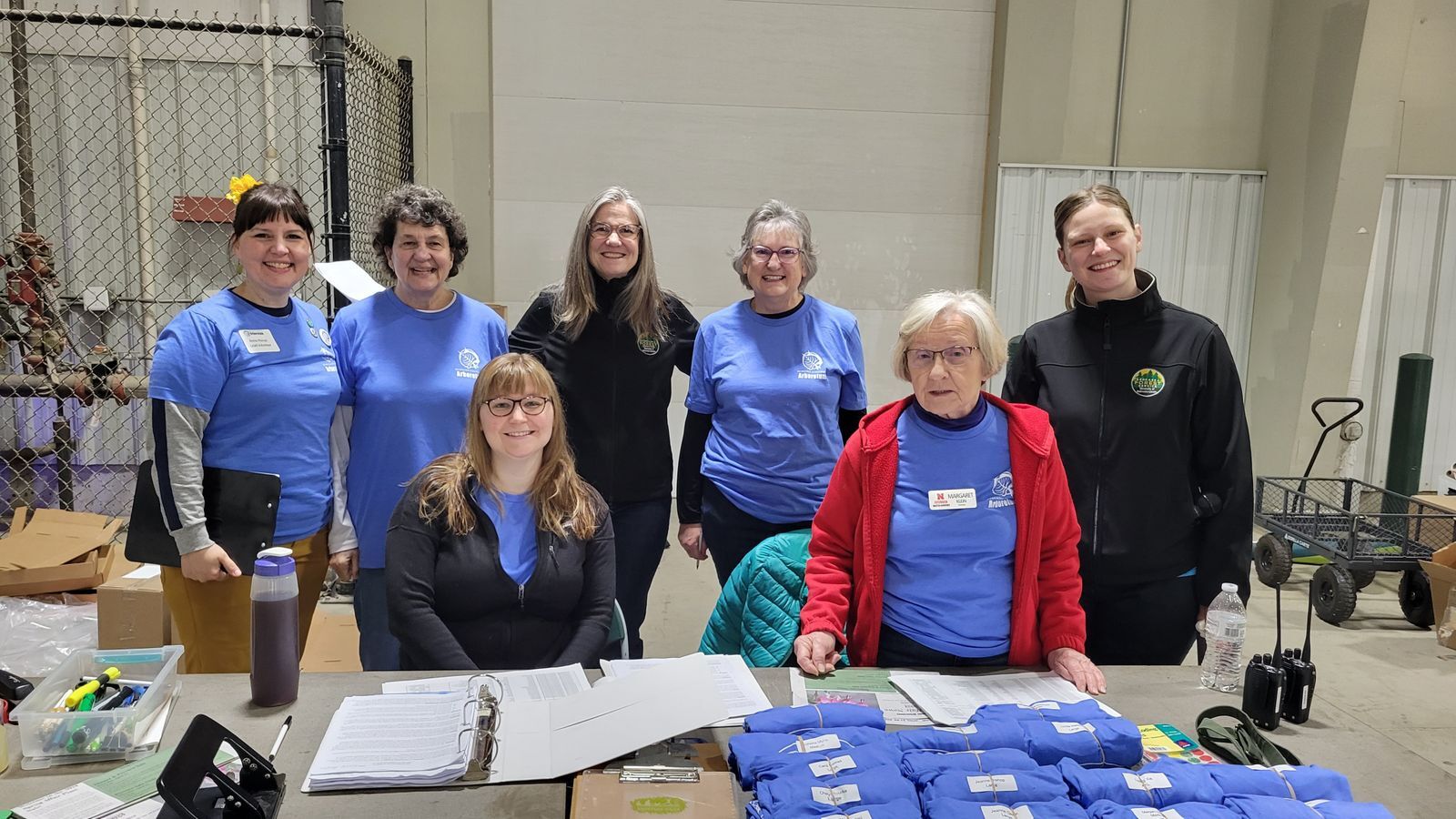 A group of women volunteers sit at a table at Spring Affair