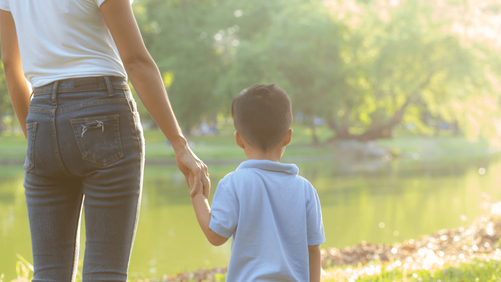 parent and child holding hands outside