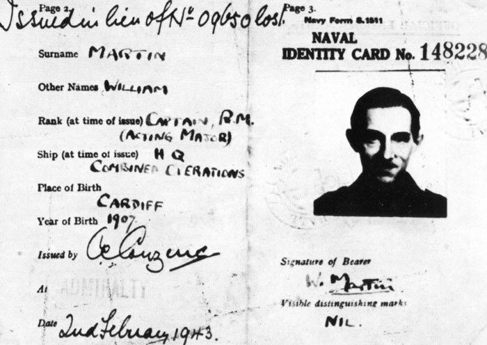 A black and white photo of a naval identity card, with a decription on the left and photo of a young man on the right.