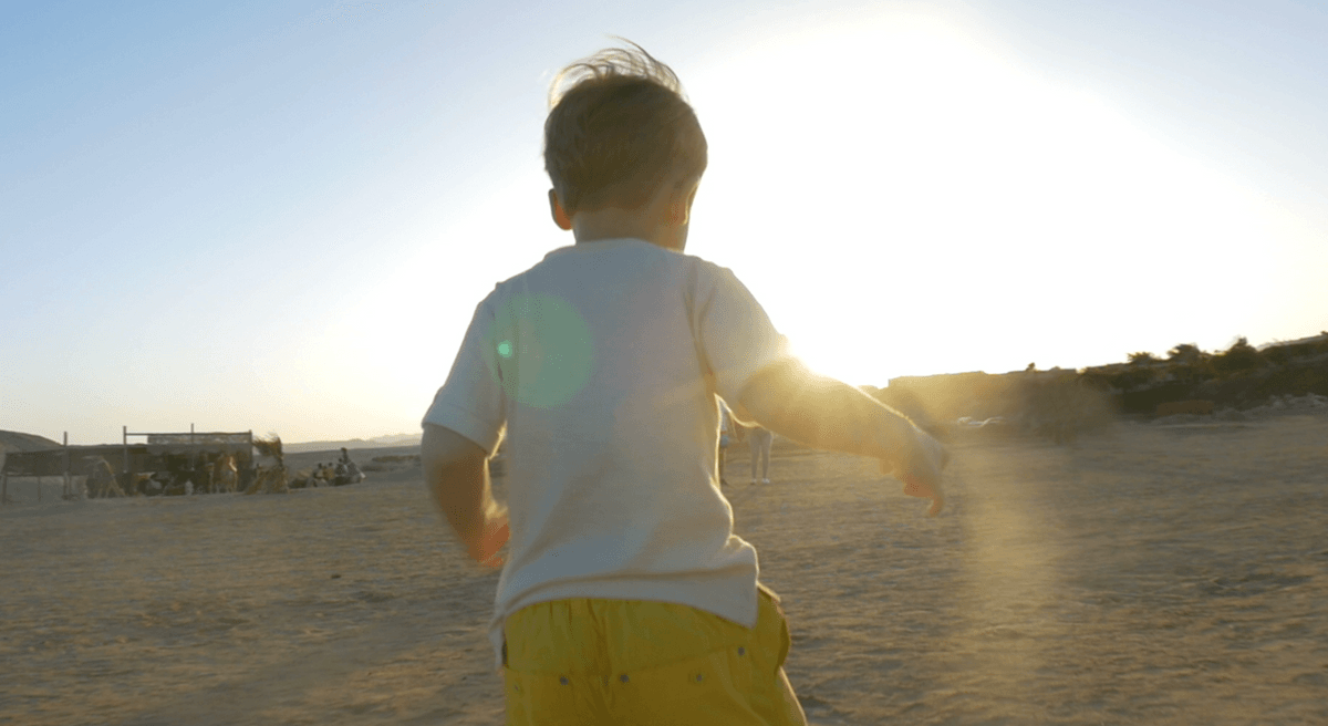 child running towards the sun