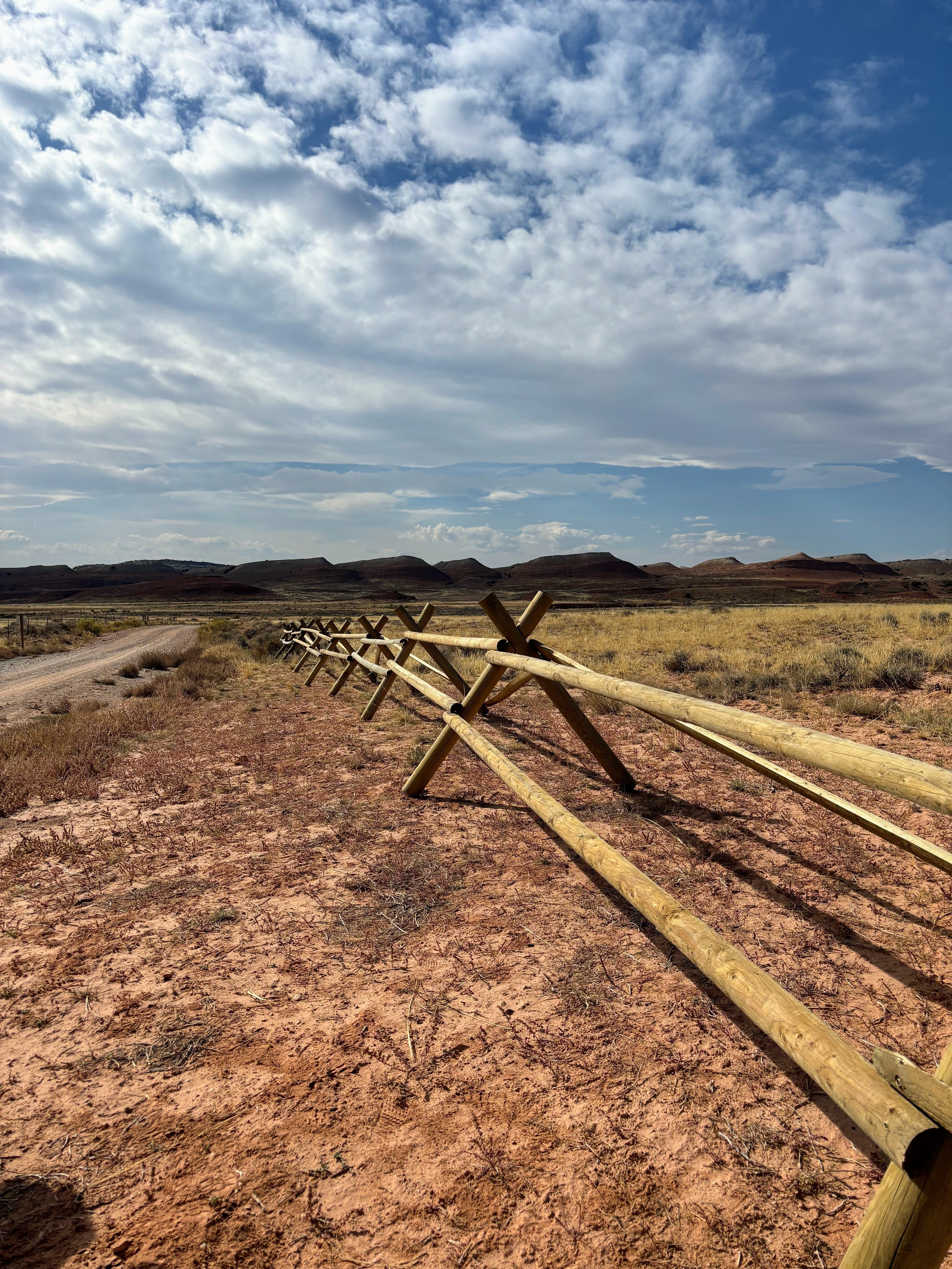 A view of a fence line in the desert.