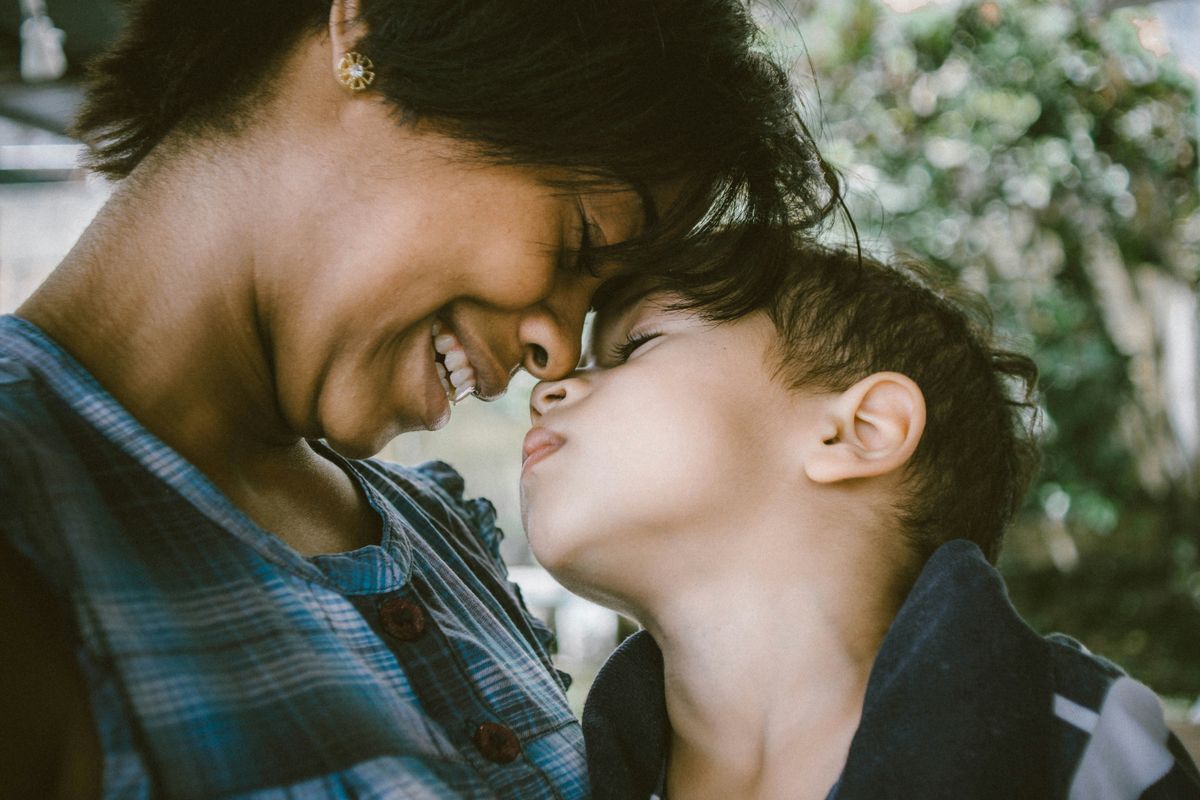 Woman and boy smiling at each other