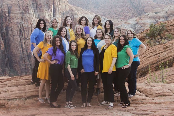 Cherish Families staff posing in front of the beautiful red mountains of Southern Utah
