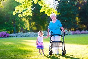 Elderly woman walking with a child.