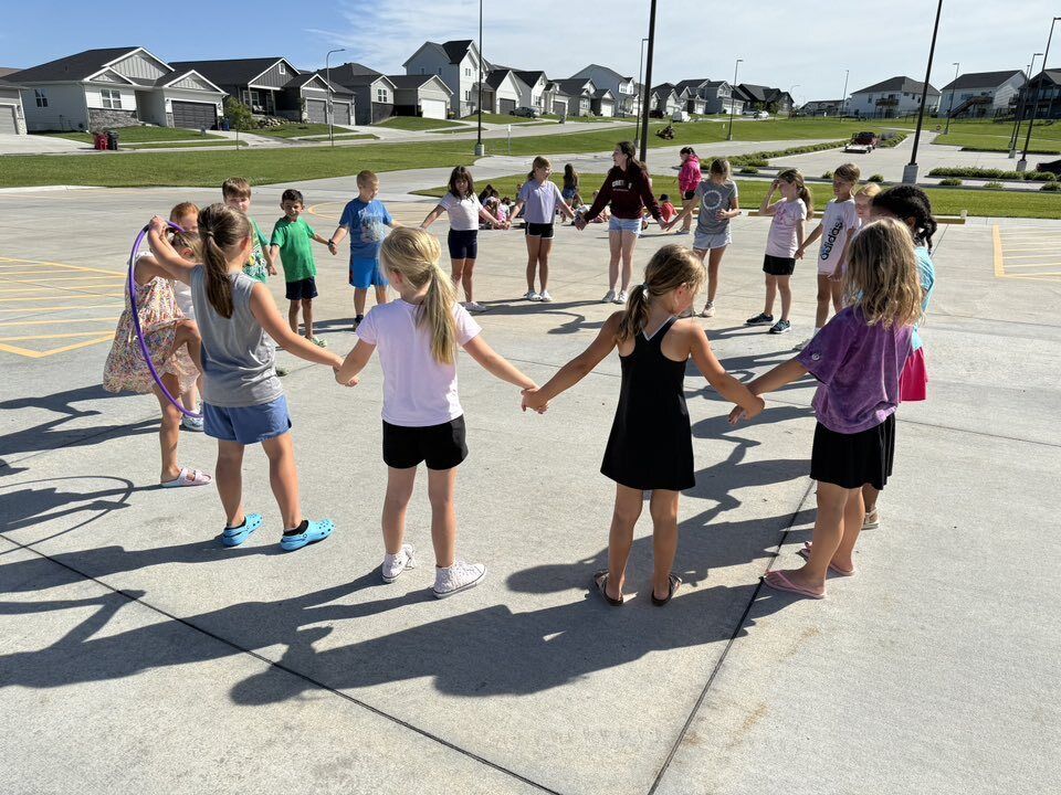 Students in a circle holding hands