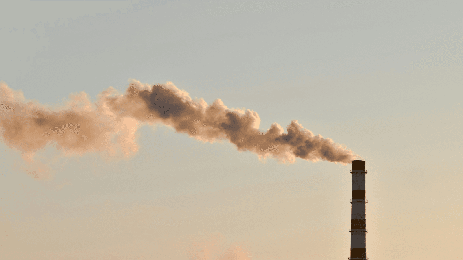 Photo of industrial chimney releasing smoke