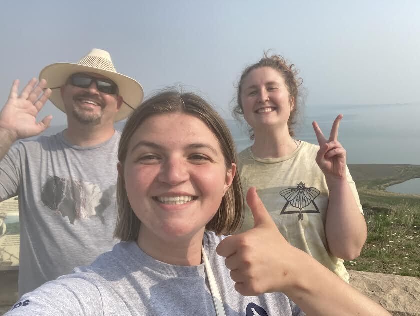 Annie takes a selfie with her coworkers.