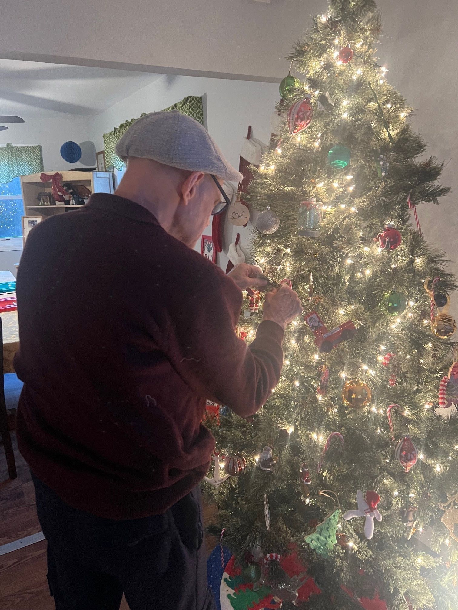 Man decorating a Christmas tree