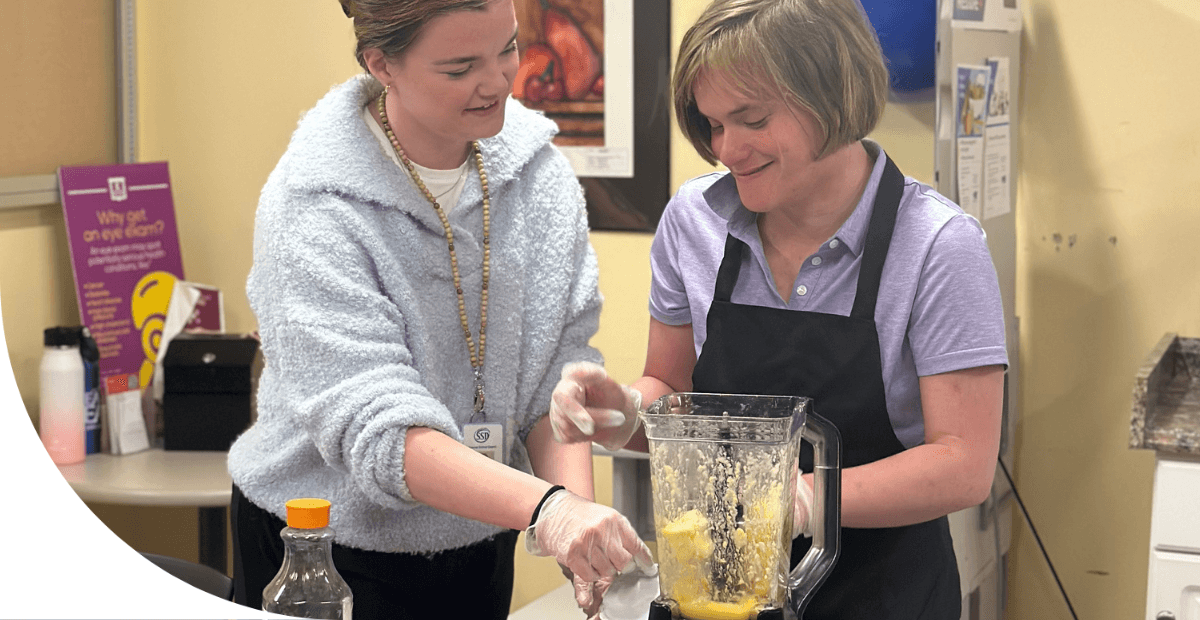 girls using a blender to make a smoothie