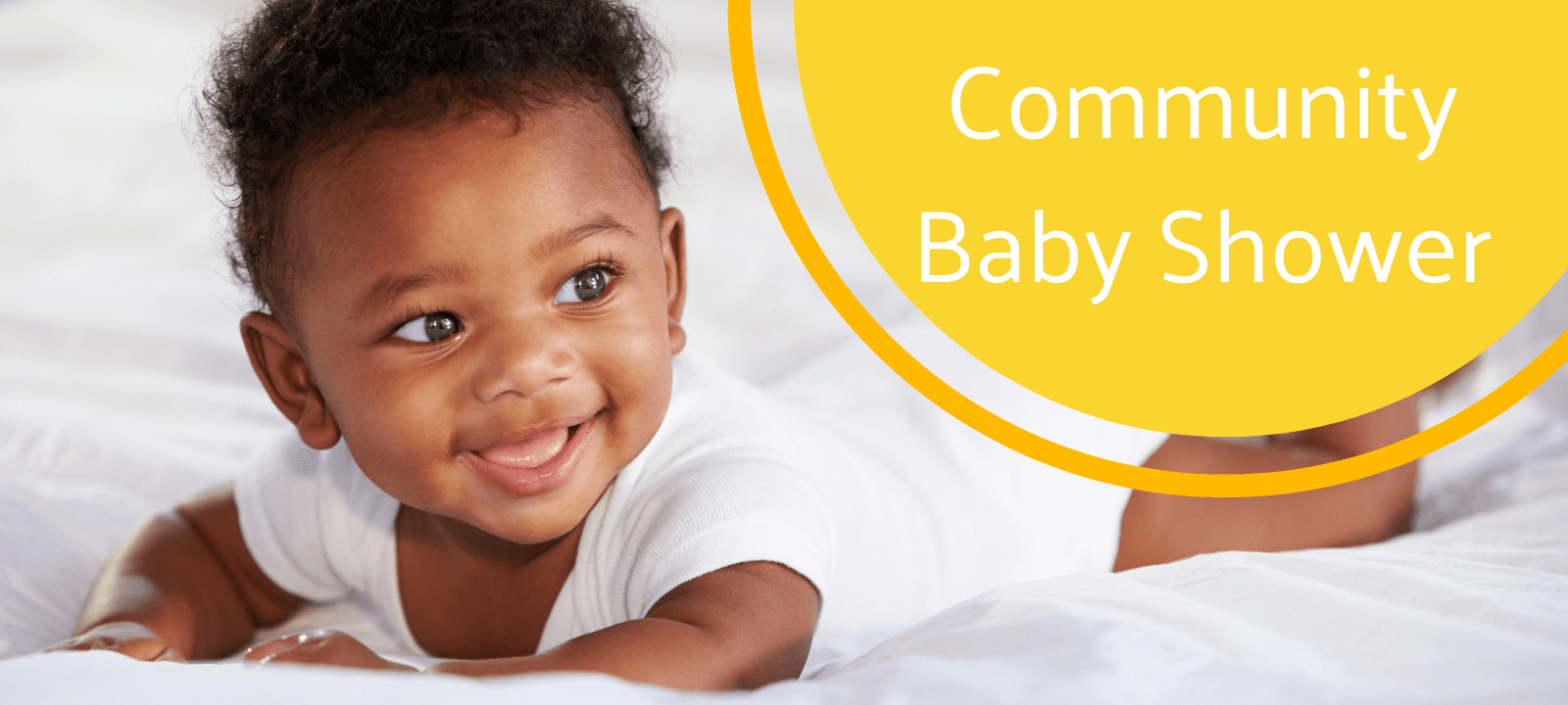 baby in white clothing smiling 