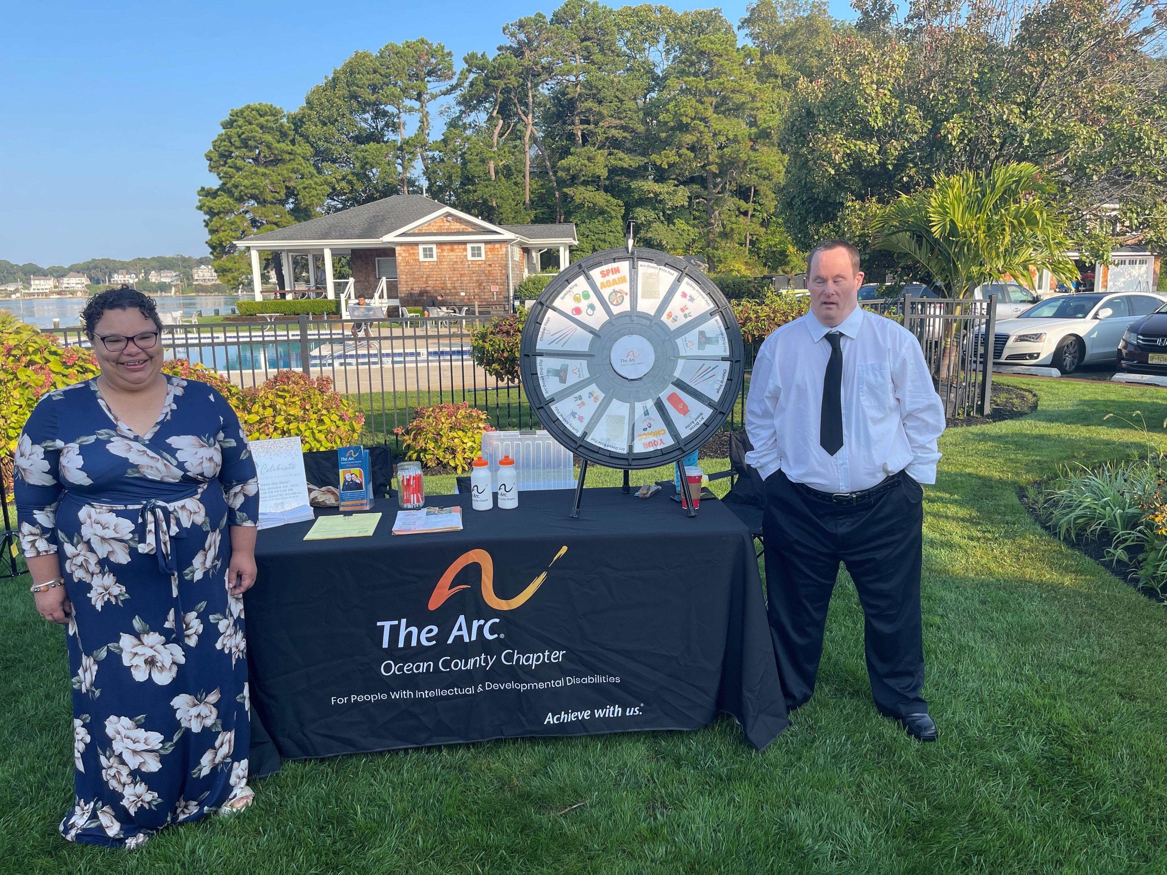 Woman and man standing next to Arc display table