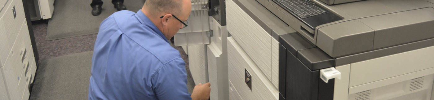 Eakes Service Technician Working on Copier