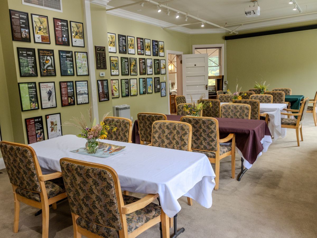 Photo of tables and chairs in the Bird Fest Room set up for a dinner style rental.