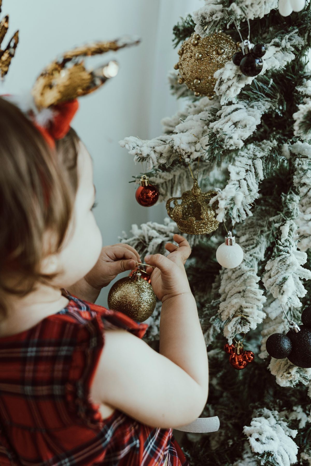 girl decorating christmas tree