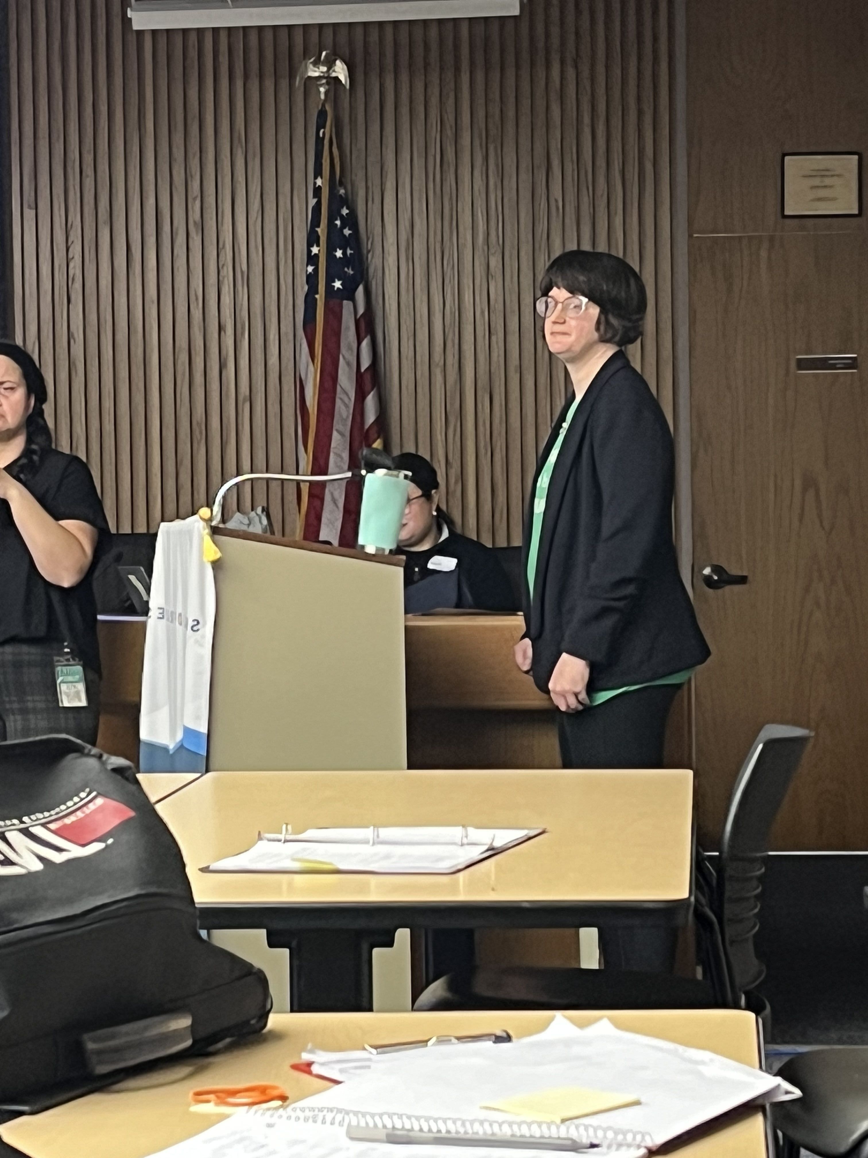 A teacher talking at a podium