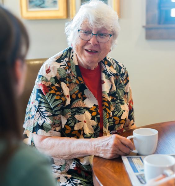 Elder talking over coffee.