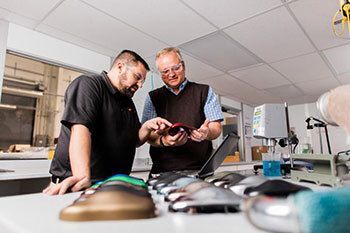 People inspecting parts.