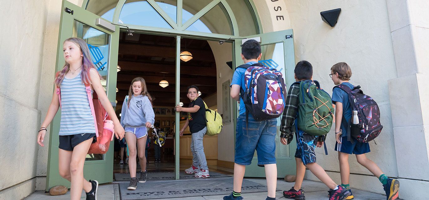 Kids walking in and out of school.