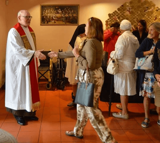 Carmelite Father Michael Driscoll greets friends