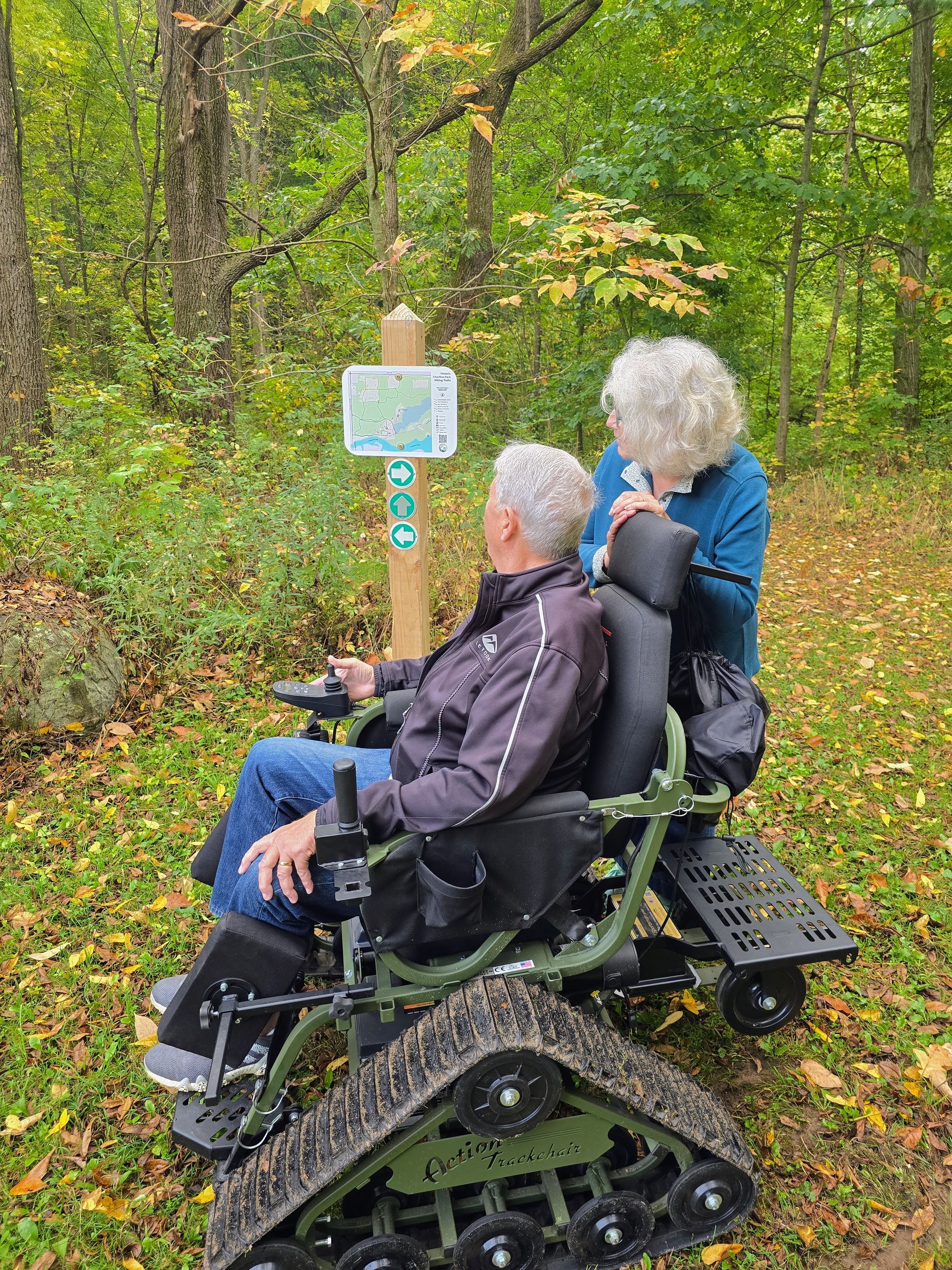 Track chair on a green grassy hill.