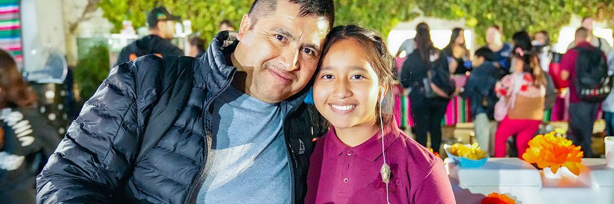 Father and daughter having a good time during a community event.