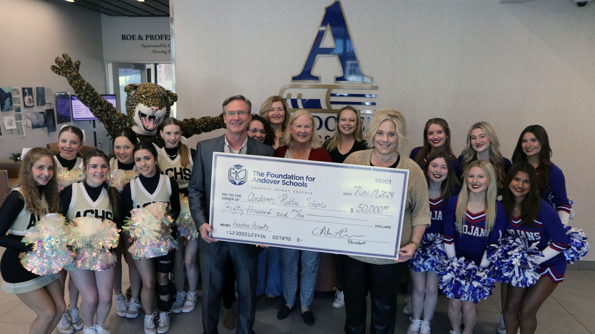 Foundation members presenting large check to superintendent