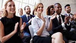 Group of business people clapping their hands.