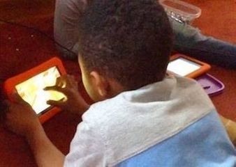 Kid playing on a tablet.
