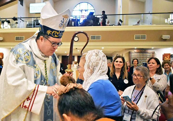 Bishop Manuel de Jesús Rodríguez greets women as he processes to the altar for Mass during the Palm Beach Diocese Council of Catholic Women conference at Our Lady Queen of the Apostles Church March 14, 2026.