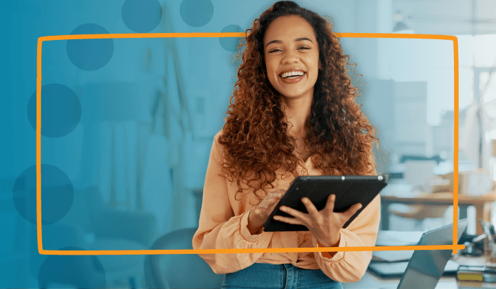 Woman smiling holding a tablet.