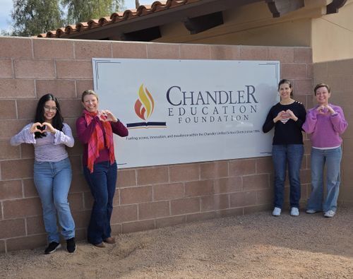 CEF staff in front of sign