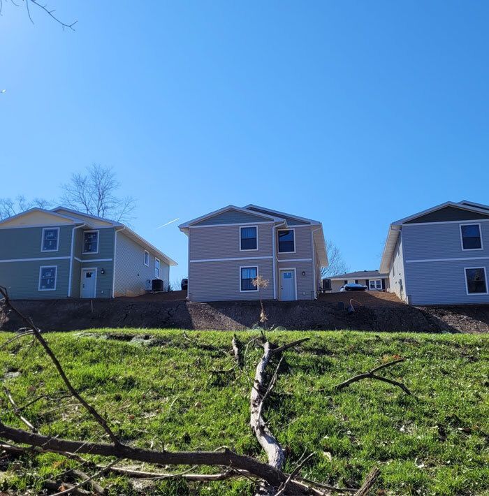 Three houses on a hill