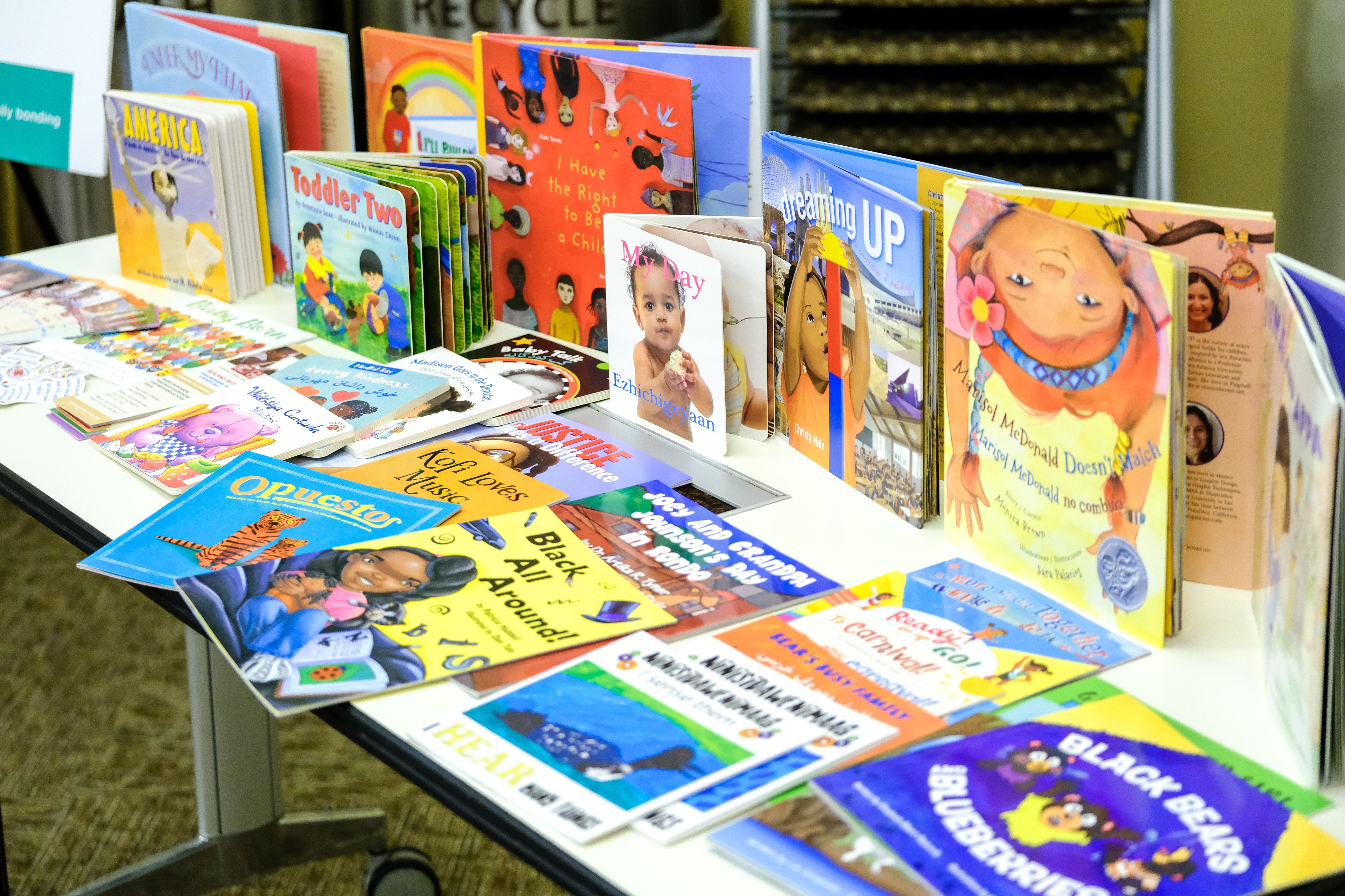 display of colorful children's books on table