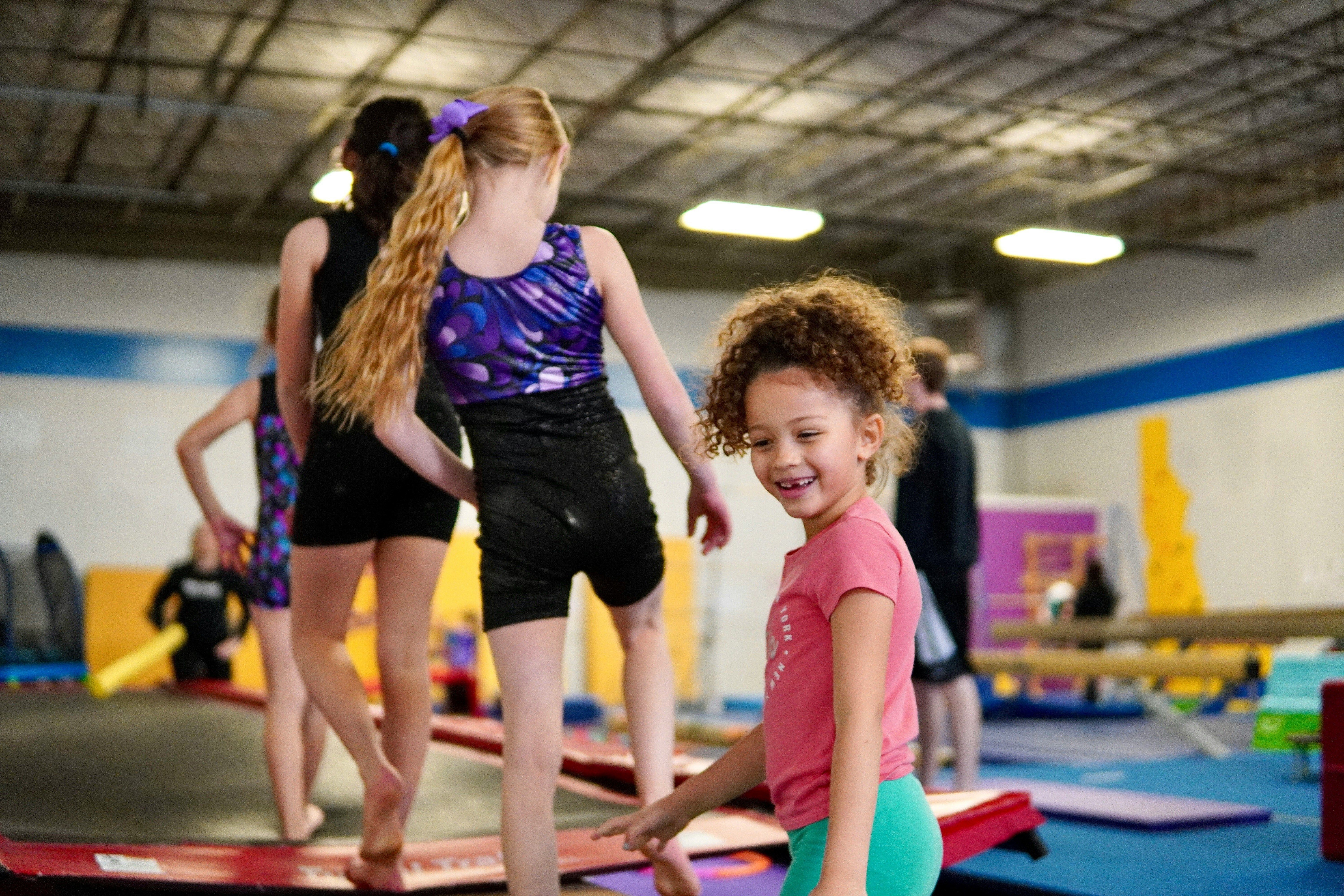 girls in a gym on exercise equipment