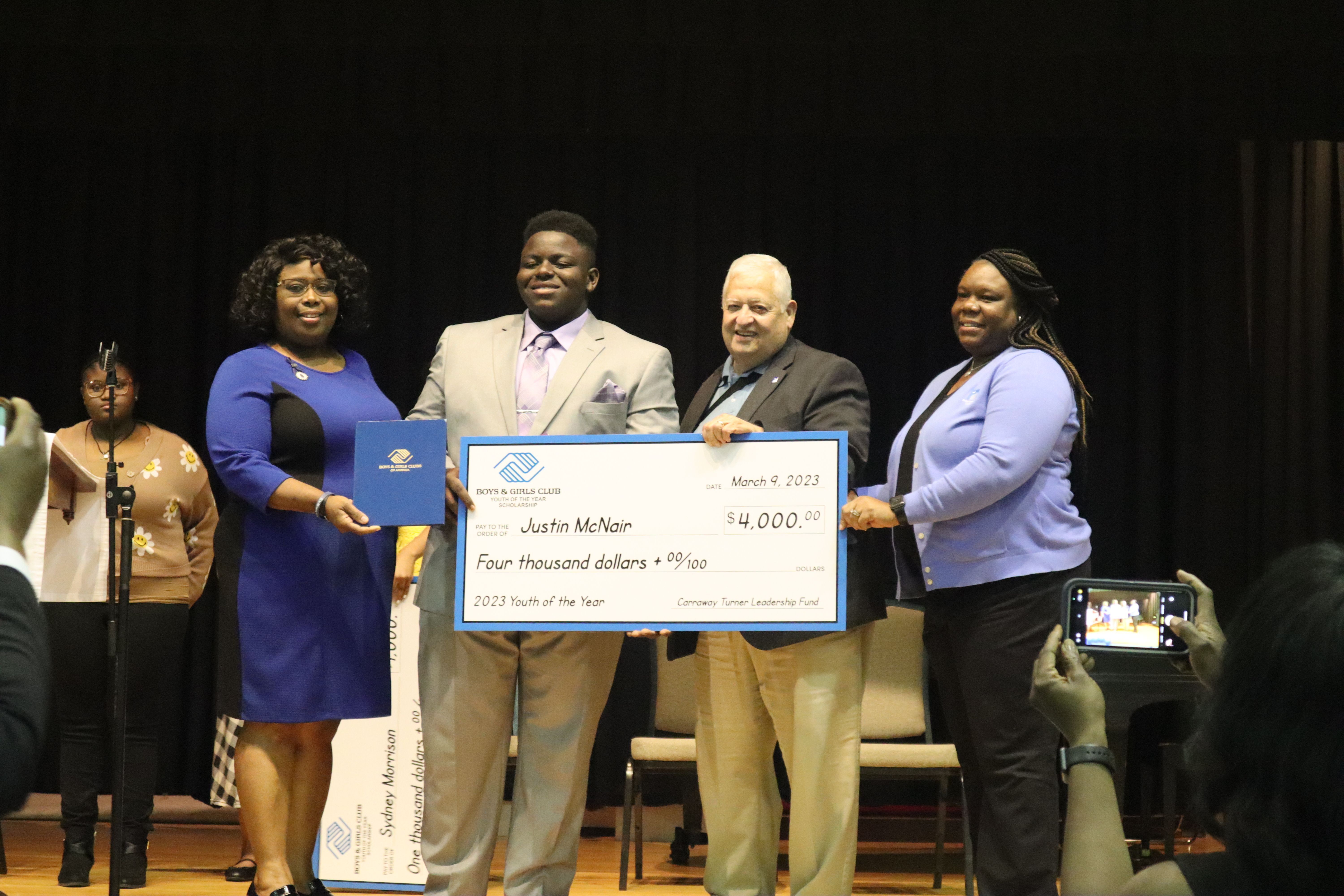 Justin McNair accepts a $4,000 scholarship from The Carraway Turner Leadership Fund.