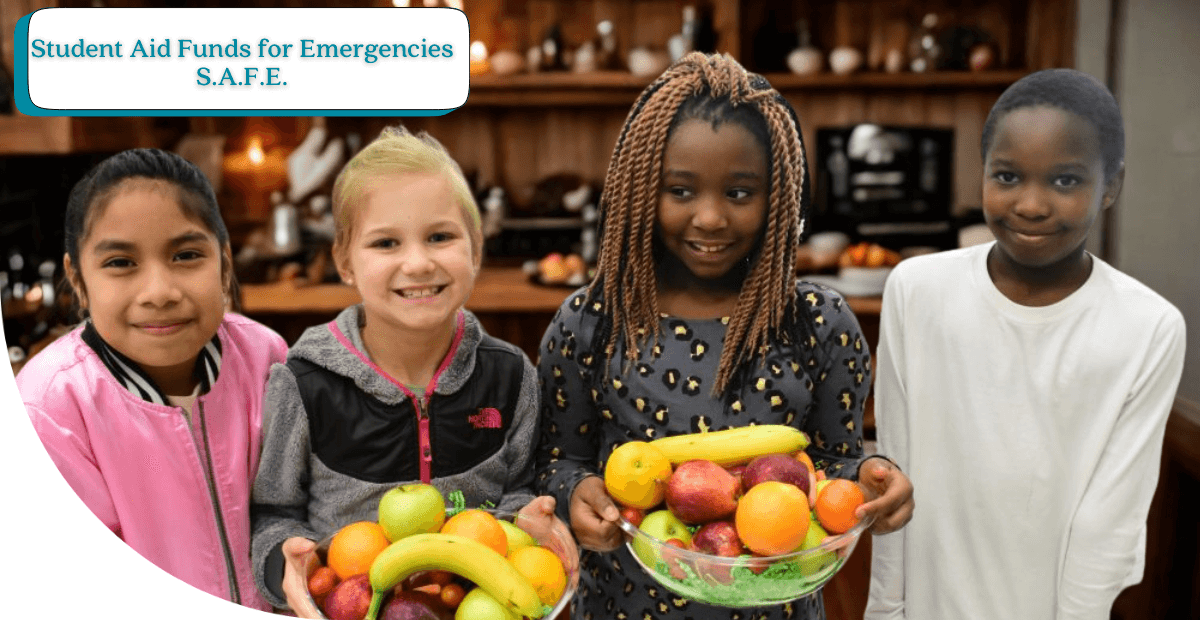 four smiling kids holding baskets of fruit