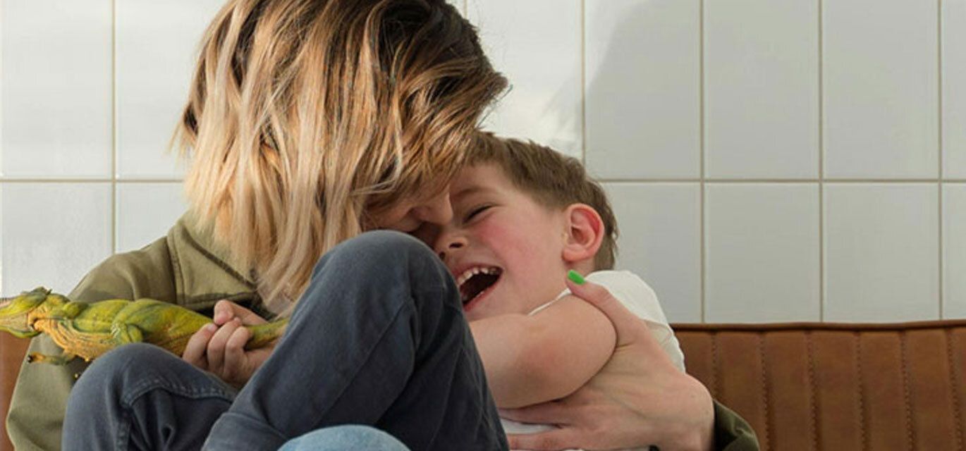 Mother holding a smiling boy