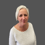 White woman in a white knit sweater on a dark gray background