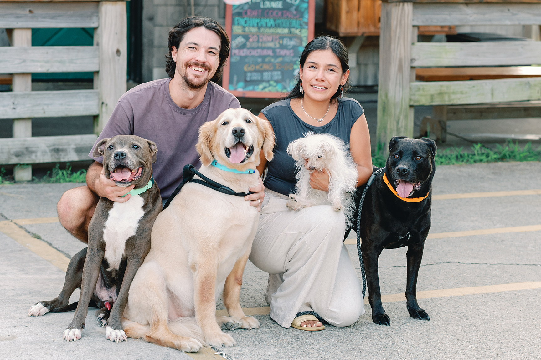 Seth and Jharixa Pugh with their family of canines in front of Huanchaco Lounge.