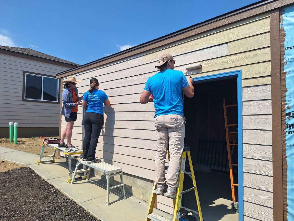 Habitat Colorado Build: Volunteer Painting outside of the garage