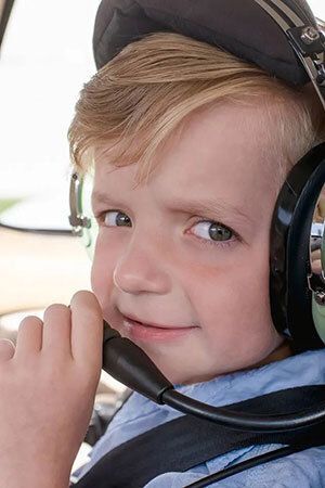 A child with an airplane headset on.