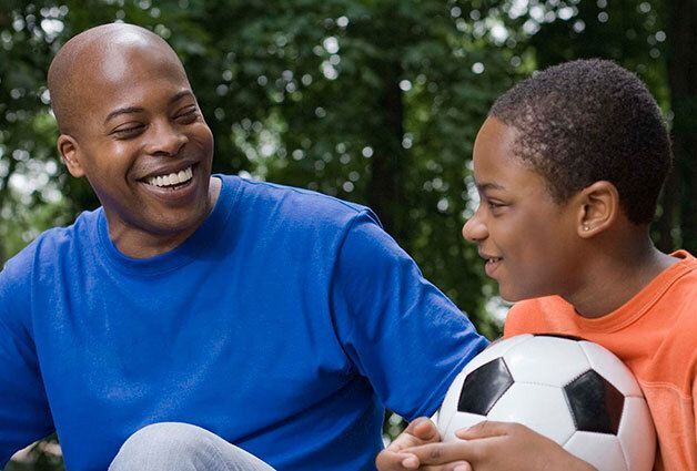 Man and boy with soccer ball