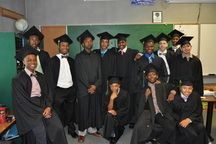 Boys in graduation caps and gowns.