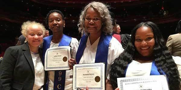 Women smiling with awards.