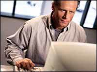 Man At Computer Looking For Information
