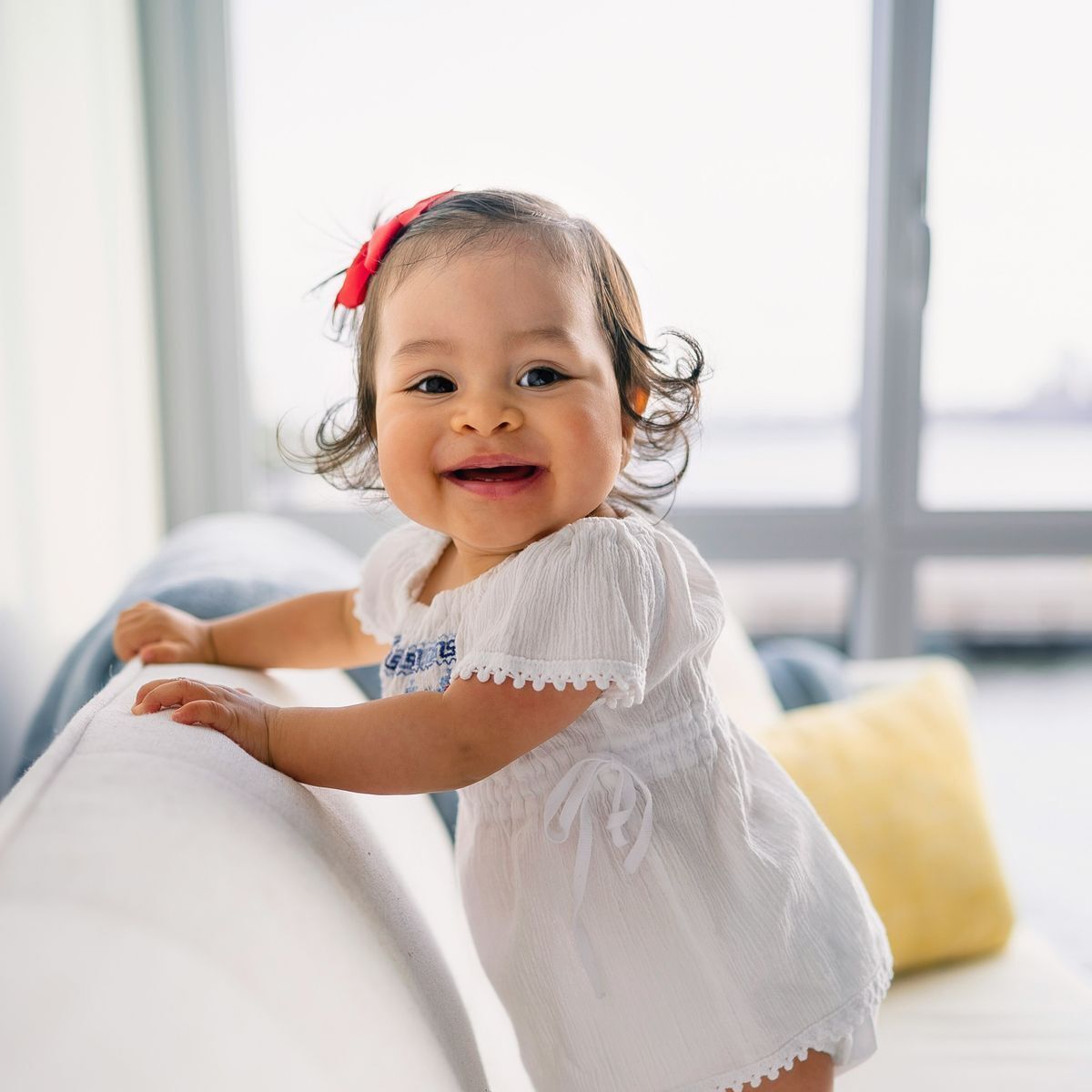A child leaning on a chair.