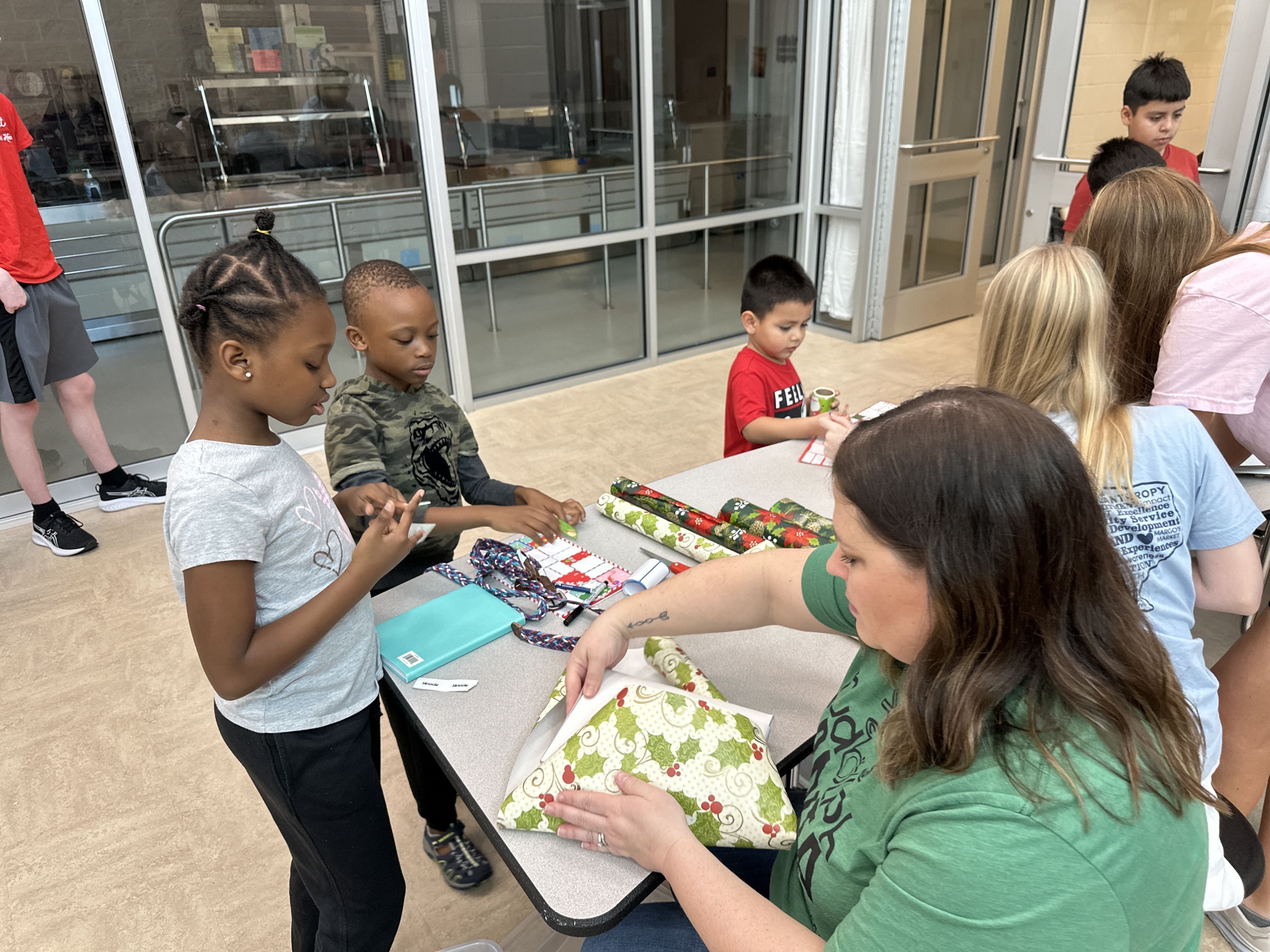 Children wrapping Christmas gifts